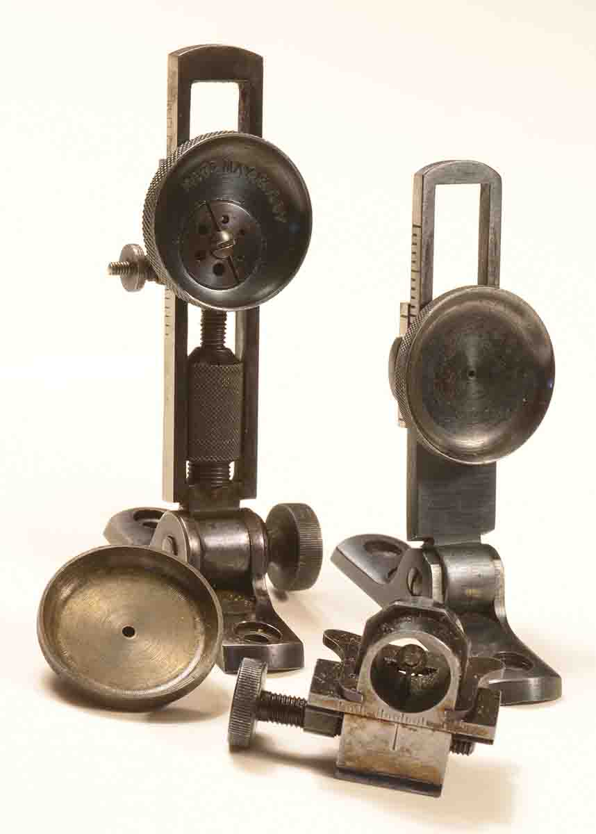 Stevens made a complete line of sights for its rifles, from the most basic to sophisticated Schützen tang aperture and globe front sights. Original Stevens sights are prized by collectors. At left is a No. 130 midrange elevating Vernier tang sight with Hadley eyecup and fixed aperture eyepiece. At right is a No. 102 Vernier shown with a front globe wind gauge front sight with  interchangeable disks.